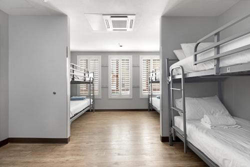 a room with two bunk beds and a hallway at HI Los Angeles Santa Monica Hostel in Los Angeles