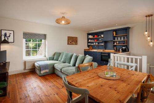 a living room with a table and a couch at Beachborough Country House in Barnstaple