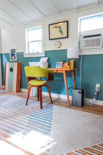 a living room with a desk and a chair at Luxurious Bohemian Bungalow in Lincolnville - Mins from Downtown! in Saint Augustine