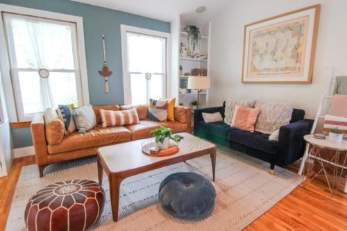 a living room with two couches and a table at Luxurious Bohemian Bungalow in Lincolnville - Mins from Downtown! in Saint Augustine