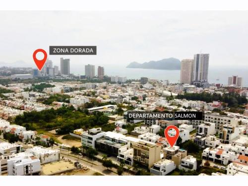 a view of a city with two red signs at Excelente Depa en Sabalo Country in Mazatlán