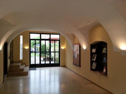 an empty hallway with a large window and a door at Gästehaus Ferk - Frühstückspension, Bed & Breakfast in Bad Radkersburg
