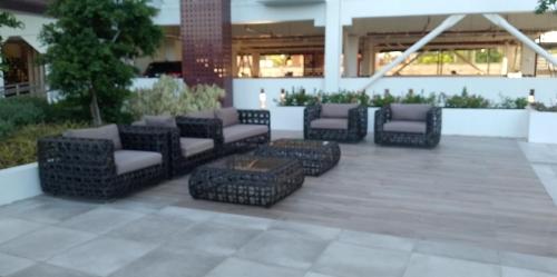 a patio with a bunch of chairs and a table at EuroAsian Royal Oceancrest Mactan in Sudtungan