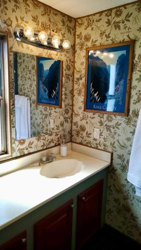 a bathroom with a sink and a mirror at Mystic Mountain Retreat in Miramonte