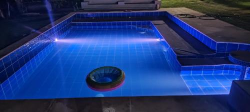 a swimming pool lit up in blue lights at Finca los mangos in La Mesa