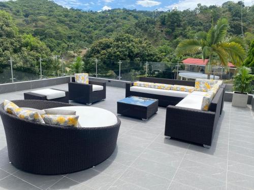 a patio with couches and tables on a roof at Finca los mangos in La Mesa