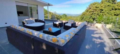 a patio with a couch and chairs on a balcony at Finca los mangos in La Mesa