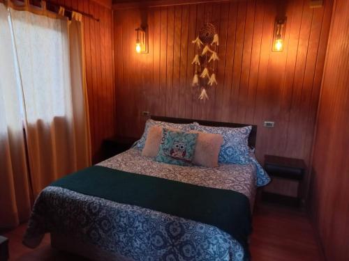 a bedroom with a large bed with wooden walls at Casa Rivadavia in Vicuña
