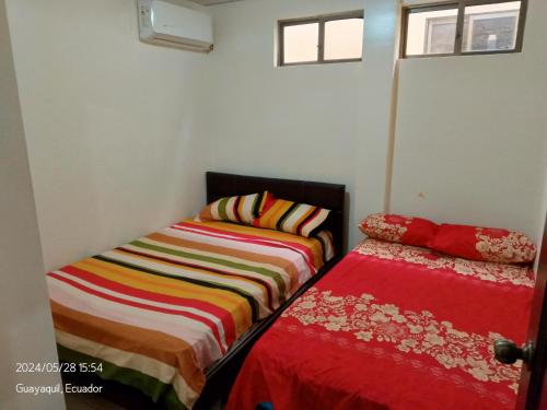 dos camas sentadas una al lado de la otra en una habitación en Suite Dpto 3dorms 6 camas 1-9personas seguridad24h piscina en Guayaquil