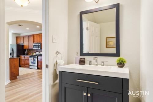 a bathroom with a sink and a mirror at Perfect Central Location w Free Prkg and Cozy Beds in Austin
