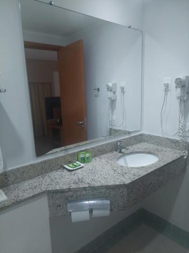 a bathroom with a sink and a mirror at Flat Borges Lagoa Vl Mariana Ibirapuera com garagem UH1007 in Sao Paulo