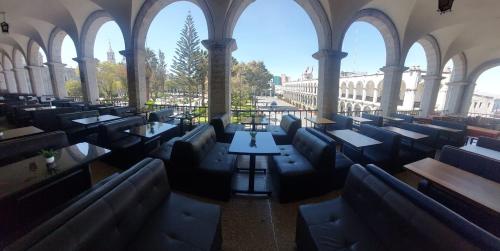 a room with benches and tables in a building at Maison plaza in Arequipa