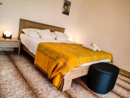 a bedroom with a large bed with an orange blanket at Apartman Damir in Sumartin