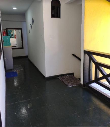 an empty room with a room with a door and a floor at Suites Mar Azul Prainha in Arraial do Cabo