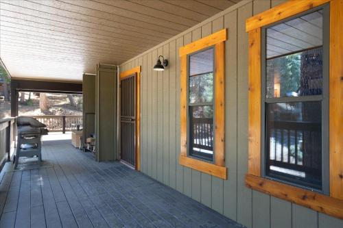 a porch of a house with two windows and a door at Quail Crossing Lodge in Yosemite West