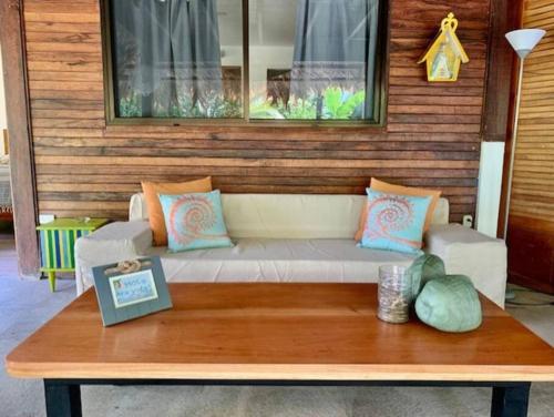 a couch sitting under a window on a table at Punta Uva Puerto Viejo Beach Front House in Punta Uva
