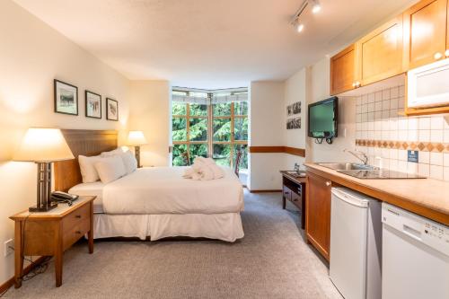 a hotel room with a bed and a sink at Cascade by Elevate Vacations in Whistler