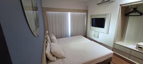 Ένα ή περισσότερα κρεβάτια σε δωμάτιο στο Flat Brisa - Hotel Mercure Navegantes