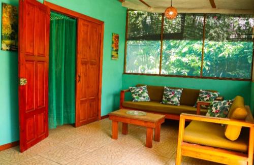 a living room with a couch and a table at Villas Advi in Puerto Viejo