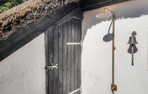 a door on the side of a building with a bell at Amazing Home In Ulfborg With Kitchen in Ulfborg