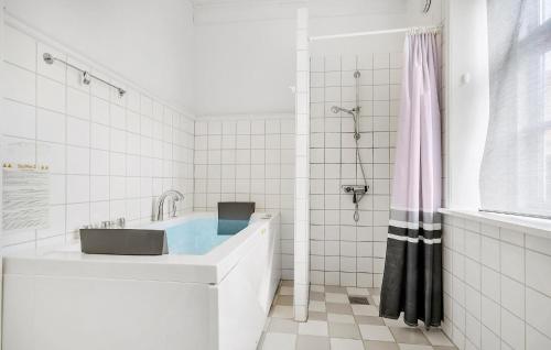 a white bathroom with a sink and a shower at Gorgeous Home In Bredebro With Wifi in Bredebro