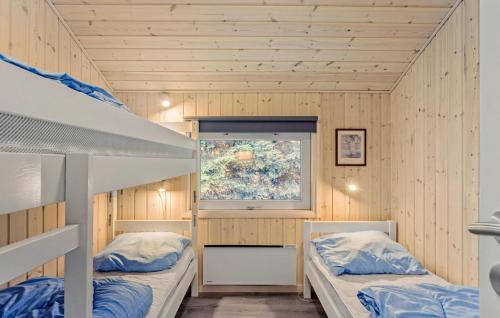 two bunk beds in a room with a window at Stunning Home In Tranekær With Sauna in Tranekær