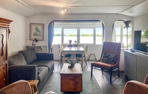 a living room with a couch and a table at Stunning Stacaravan In Reeuwijk in Reeuwijk