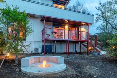 a house with a fire pit in front of it at Villa Secca in Futo