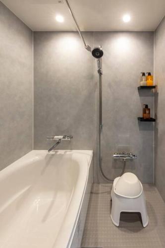 a bathroom with a white tub and a toilet at Villa Secca in Futo