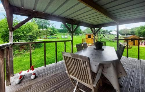 a patio with a table and chairs on a deck at Awesome Home In Alette With Wifi in Alette