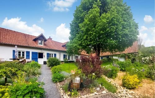 a garden in front of a house with a tree at Awesome Home In Alette With Wifi in Alette