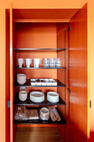 a pantry with plates and dishes on shelves at Villa Secca in Futo