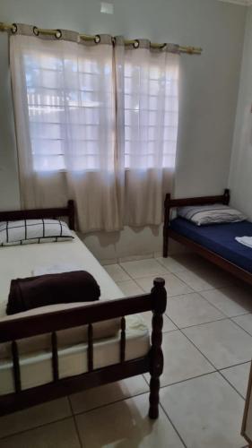 Ένα ή περισσότερα κρεβάτια σε δωμάτιο στο Hospedagem Vermont