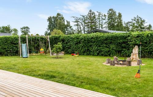 a yard with a playground and a swing set at Nice Home In Kirke Hyllinge With Wifi in Kirke-Hyllinge