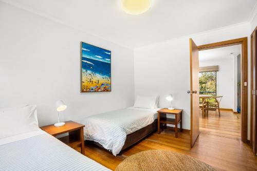 a bedroom with two beds and a table and chairs at Aireys Inlet Getaway in Aireys Inlet