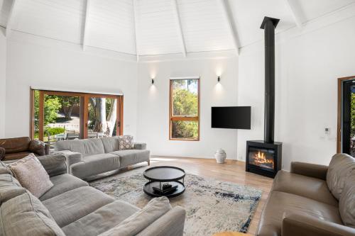 a living room with a couch and a fireplace at Aireys Inlet Getaway in Aireys Inlet