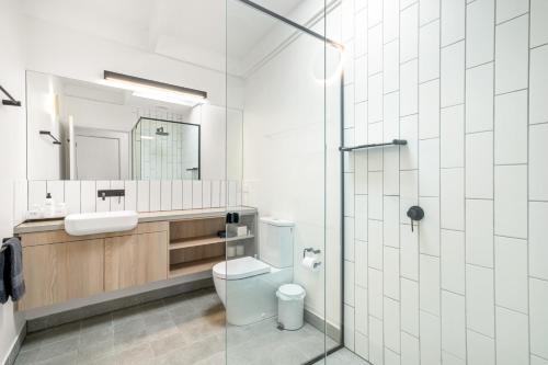 a bathroom with a toilet and a sink and a mirror at Aireys Inlet Getaway in Aireys Inlet