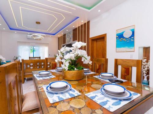 a dining room with a table with plates on it at Villa doña kika in San Felipe de Puerto Plata