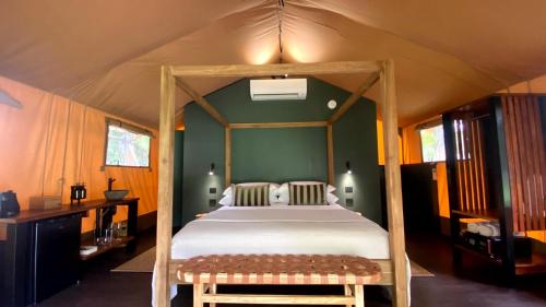 a bedroom with a canopy bed in a tent at Daintree Beach Resort in Wonga
