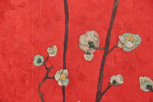 a painting of flowers on a red wall at 料理旅館ゆり野 in Wajiki