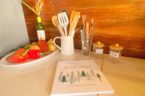 a welcome sign and a plate of vegetables on a counter at Azul Vista Drake Bay-AC-Full Kitchen in Drake