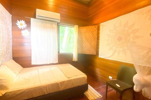 a small bedroom with a bed and a window at Azul Vista Drake Bay-AC-Full Kitchen in Drake