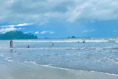a group of people in the water at the beach at Azul Vista Drake Bay-AC-Full Kitchen in Drake