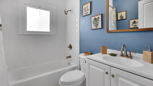 a bathroom with a white toilet and a sink at Beaches, Parks, Downtown, Trail, Breweries, Bikes, Gameroom in Palm Harbor