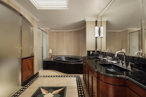 a bathroom with two sinks and a large mirror at The Westin Tokyo in Tokyo