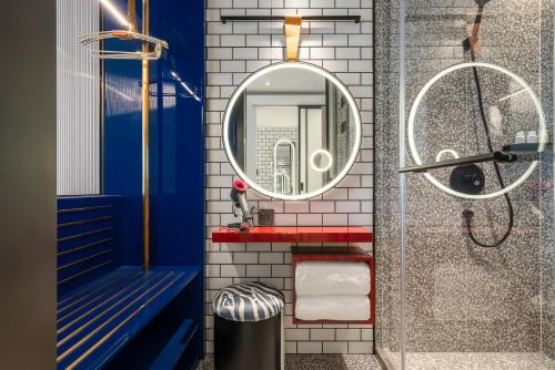 La salle de bains est pourvue d'un lavabo et d'un miroir. dans l'établissement A T HOUSE Shanghai Xujiahui, à Shanghai