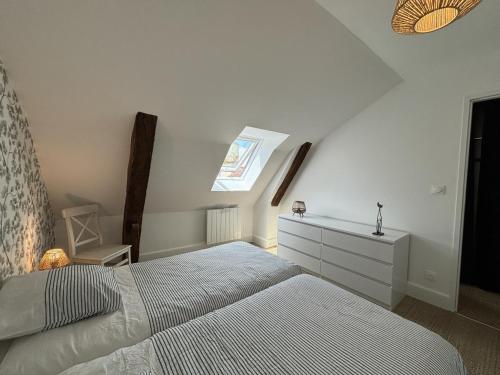 a bedroom with a bed and a dresser and a window at Duplex de charme au cœur historique de Moulins avec équipements modernes et literie incluse - FR-1-489-523 in Moulins