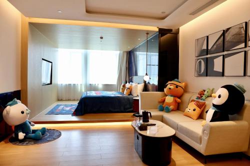 a living room with teddy bears sitting on a couch at A T HOUSE Shanghai City Center Xujiahui - Free Night Snacks from 930pm-11pm in Shanghai