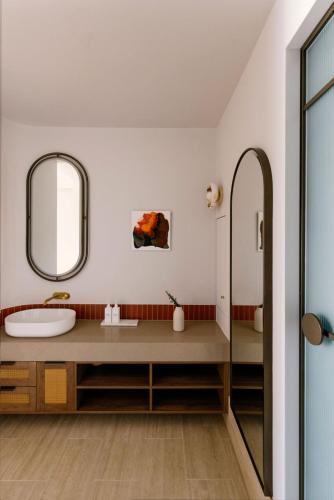 a bathroom with a sink and a mirror at Basq House in Byron Bay