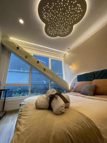a stuffed animal sitting on a bed in a bedroom at Republica del Salvador Coliving Ecuador XOE in Quito